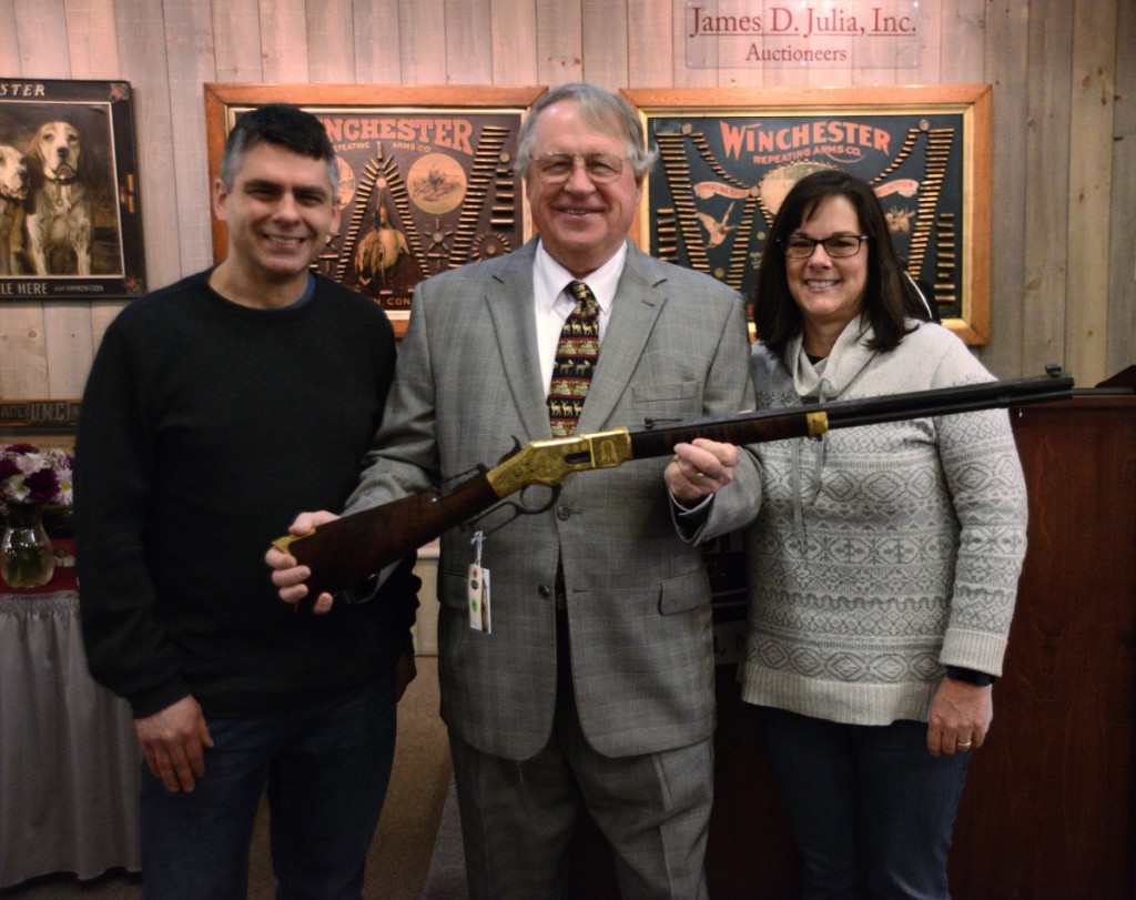 Jim Julia holding the Winchester Model 66 that sold for just under $600,000. It came from the collection of the late Ray Bentley and with Julia are Bentley’s children, Barbara Stoken and her brother, Larry. 		  —Jack Stepp photo.
