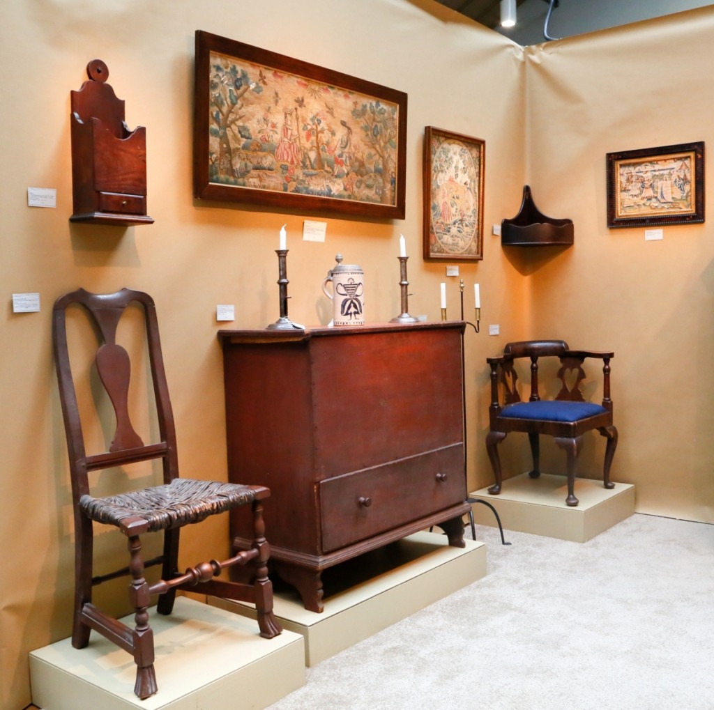 Elliott & Grace Snyder, South Egremont, Mass., believed that the diminutive one-drawer blanket chest at center was likely from Connecticut, circa 1760. It was in original condition including the red paint and shaped feet. The 1760 corner chair to the right of it was also likely from Connecticut, with a grain painted surface and heart cutout splats.