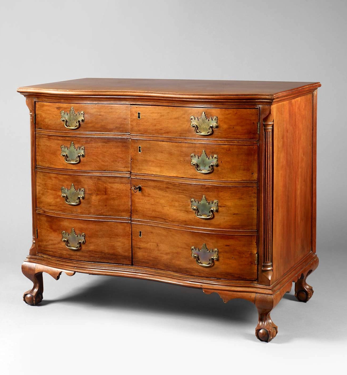 This rare, possibly made-to-order Chippendale oxbow faux-drawer cabinet has diagonal corner braces, a feature found in Litchfield, Conn. Cherry with pine and poplar secondary woods, height 35½ inches.