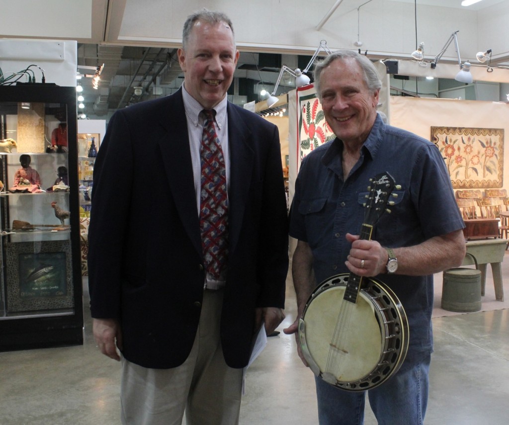 Carroll Swamm, South York, Penn., right, and Bob Backius of Mitchell Displays, Inc, discuss the features of a circa 1928 Gibson banjo mandolin that Swamm had just acquired from Carol and Gene Rappaport.