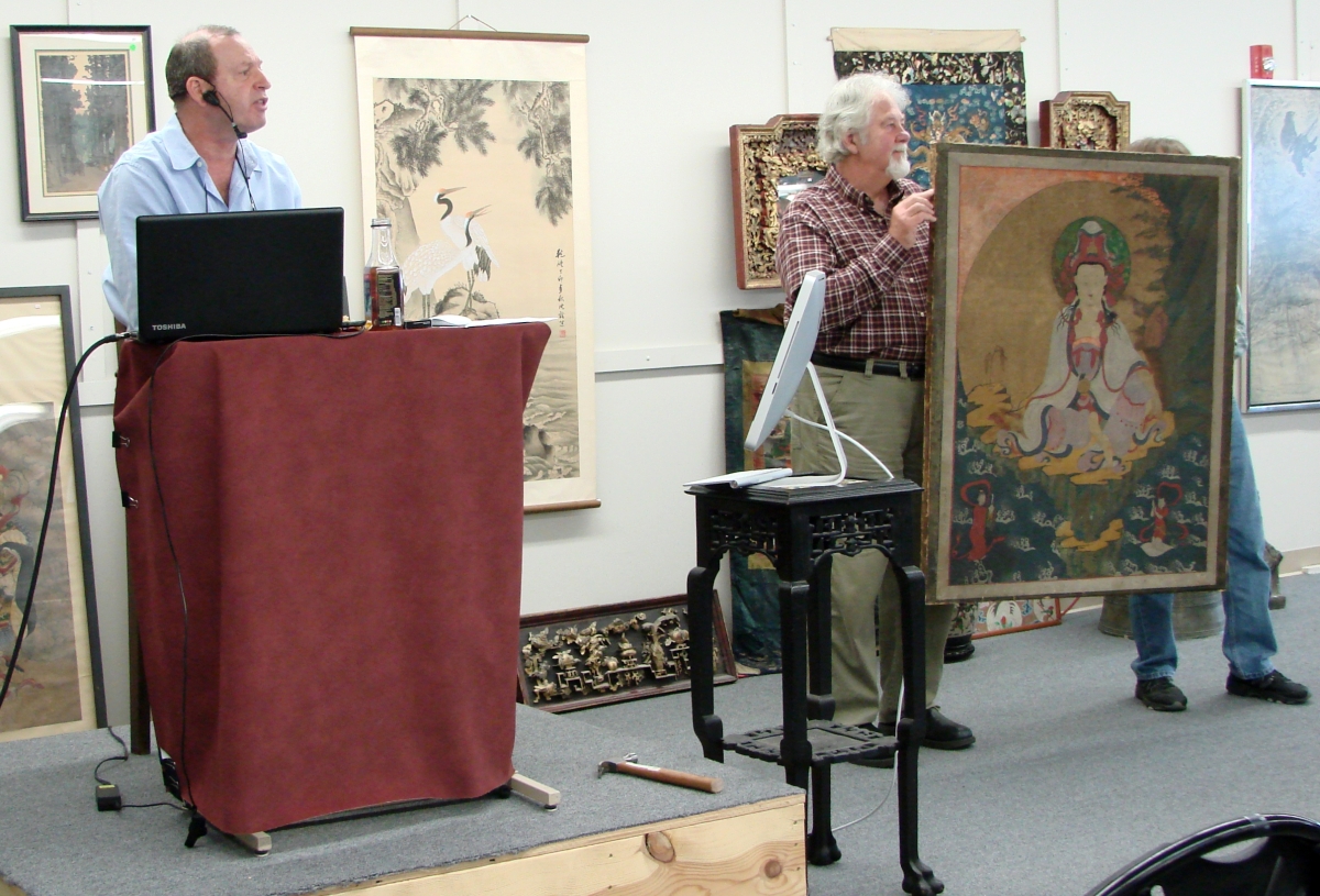 Brett Downer taking bids on the star of the sale, a Fourteenth Century Korean painting that brought more than $100,000.
