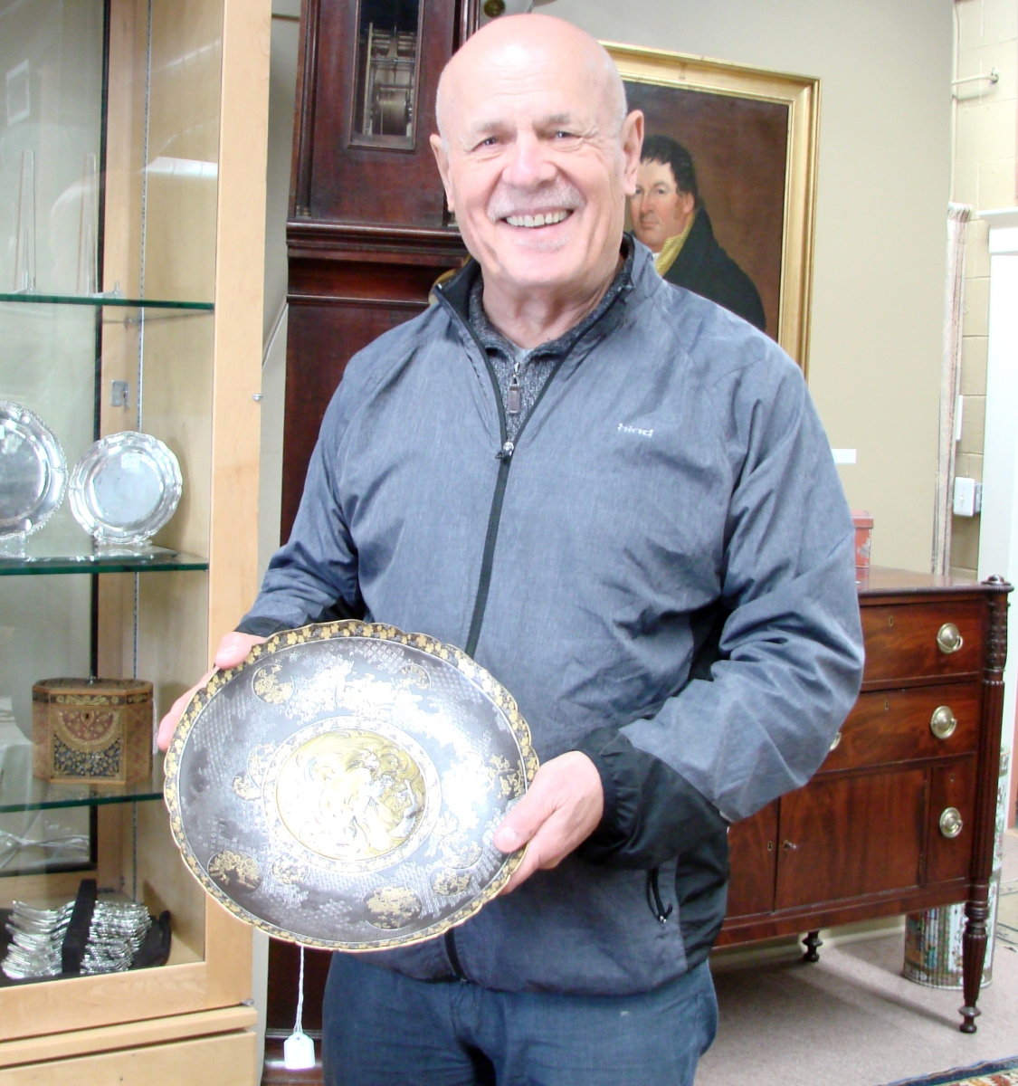 Carl Nordblom holding his favorite piece in the sale, a very well done Meiji mixed metal charger.