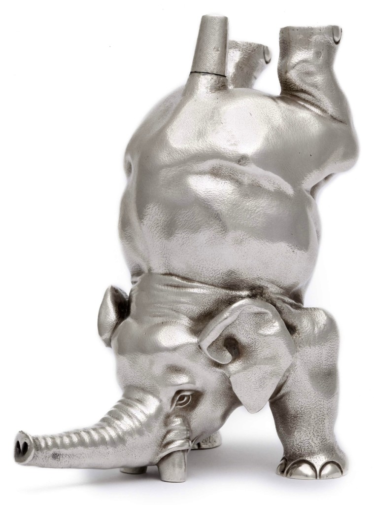 Left, silver stamp moistener in the form of an elephant standing on its tusks and forelegs, the tail serving as the moistener, Fabergé, workmaster J. Rappoport, St Petersburg, circa 1895, height 4 inches.
