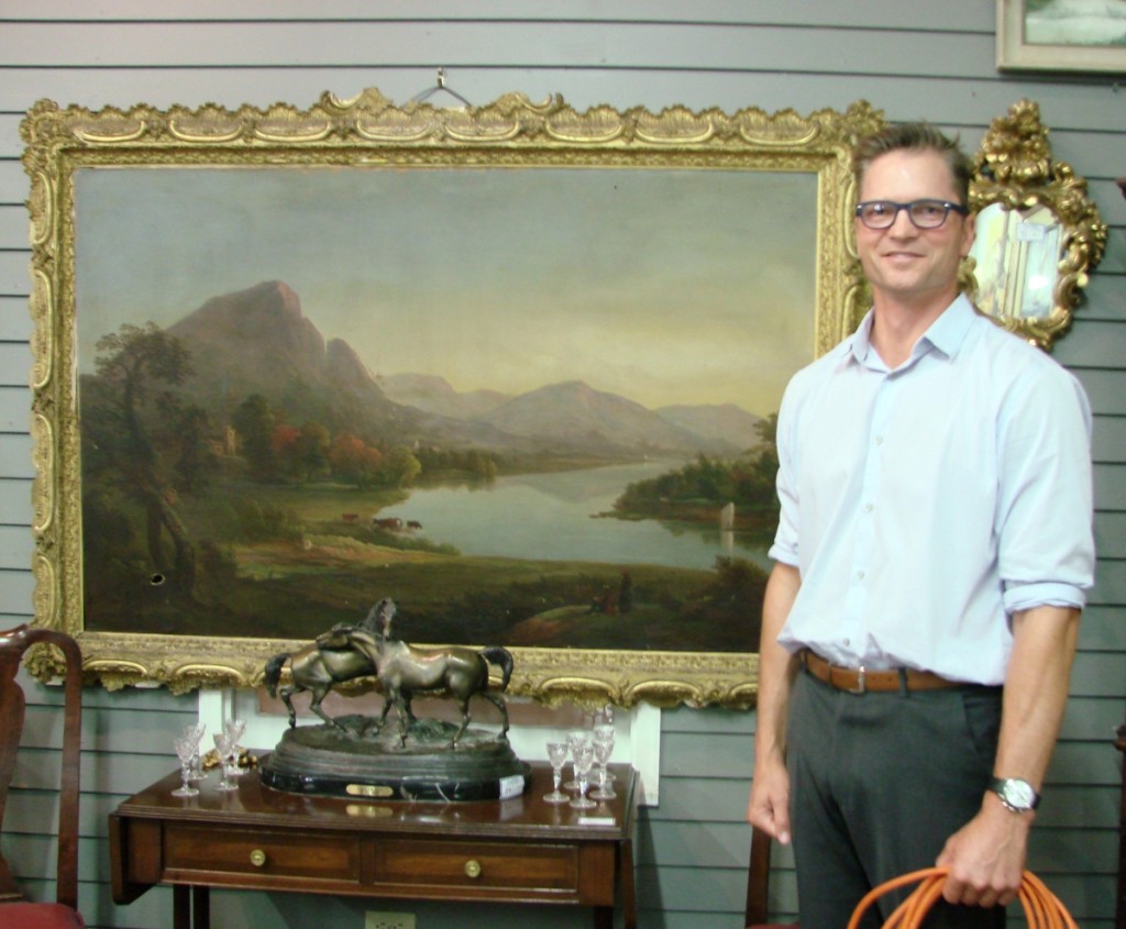 Ethan Merrill with the large Hudson River landscape, with mouse hole, which sold for $2,185.