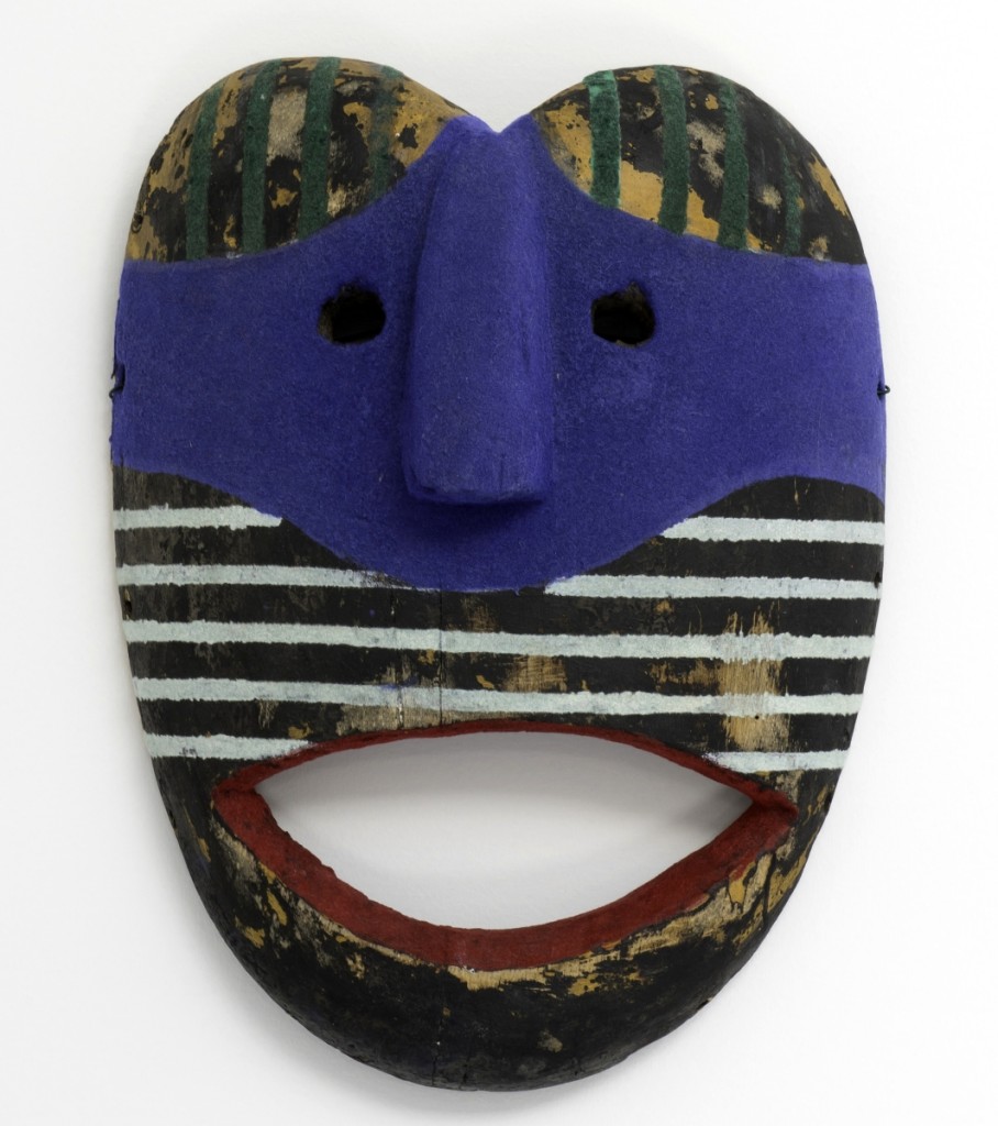 “Red Smile (Flocked Series)” by Keith Sonnier, 2011, hand painted and flocked found African mask, 12½ by 9½ by 3¾ inches, photo courtesy of the artist and Tripoli Gallery Southampton, ©Keith Sonnier.