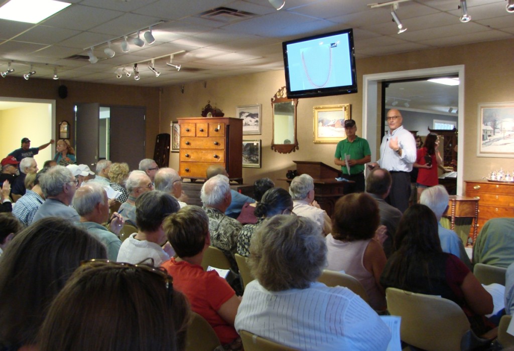 Bill Smith and Ken Labnon getting ready to sell the first lot of the day, a gold necklace.