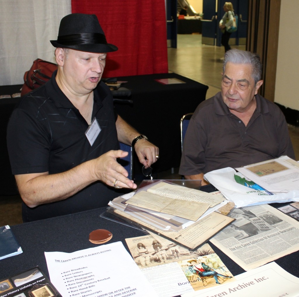 Eric Caren, left, and Jeff Anderson from Long Island conduct some business at the dealer’s booth.