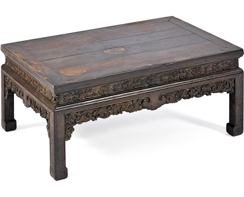A low zitan table with a ruyi and passion flower carvings came from the estate of Ambassador Charles Richard Crane (minister to China 1920–21); despite some wear on the surface, it sold at $39,000. —Eldred’s