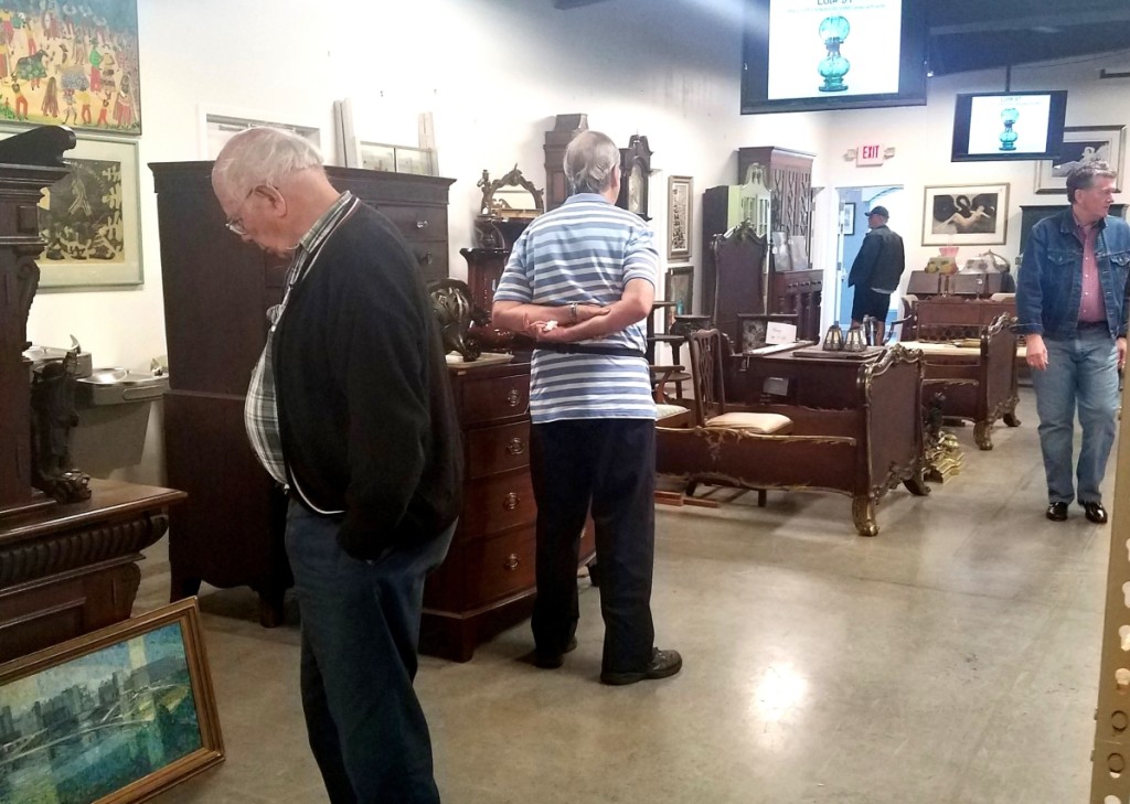 Buyers preview furniture and decorative arts for Saturday’s sale while Friday’s live auction takes place.