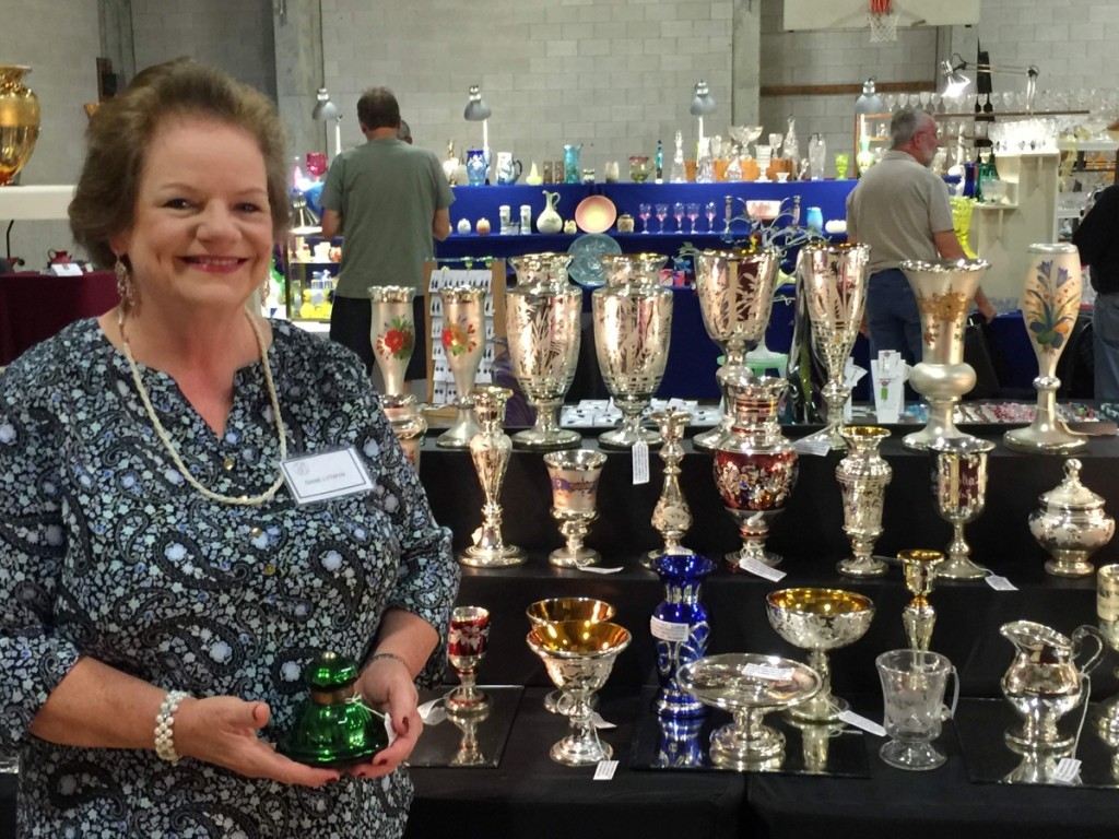 Diantiques, Diane Lytwyn, from Southport, Conn., brought her collection of mercury, Bohemian, American cut and engraved glass. She is seen here holding a signed Lunt inkwell.