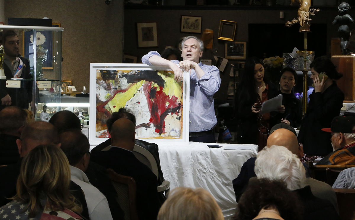 Killen takes bids on a Willem de Kooning painting on newspaper. The work sold for $72,000. 
