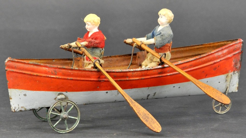 A bid of $2,700 took this French Double Oarsman pull toy in excellent condition, slightly exceeding the $2,000 high estimate. This hand painted tin boat is on wheels carrying two children with bisque heads, hands, arms and legs with cloth bodies. The rowing action begins when the toy is pulled. It measures 9 inches.