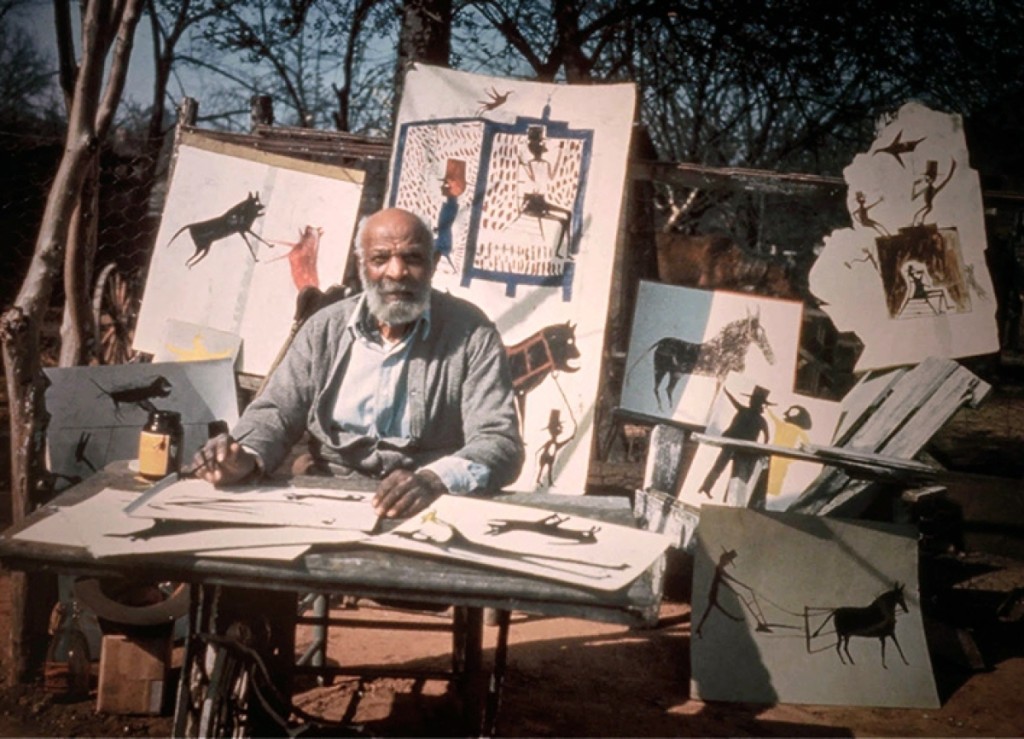 Bill Traylor sits before a display of his artwork. Photograph by Horace Perry. Courtesy Alabama State Council on the Arts.