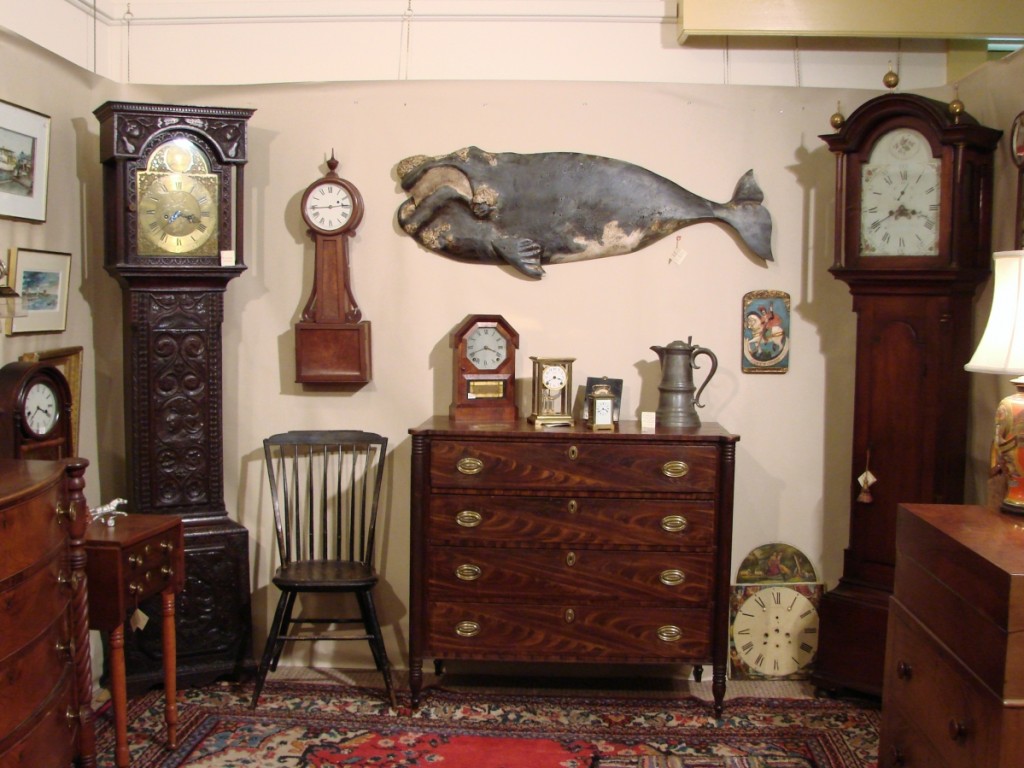 The heavily carved circa 1780 tall case clock in the corner of the booth of Harrison, Maine, dealer Harry Hepburn III was made by Joseph Atkinson in Ireland. The well-carved whale plaque by “Wick” Ahrens was priced at $8,775.