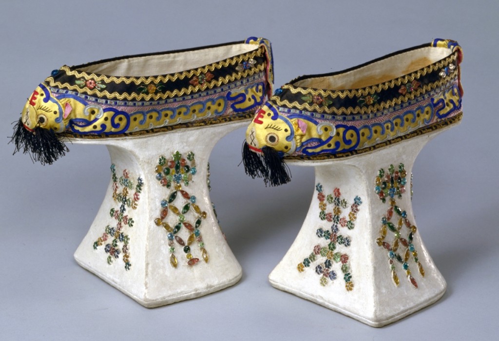 Platform shoes with tiger heads, the character for longevity, and bats, Guangxu period, 1875–1908. Appliqué, silk satin, platforms, wood core covered with cotton, glass beads. ©The Palace Museum.