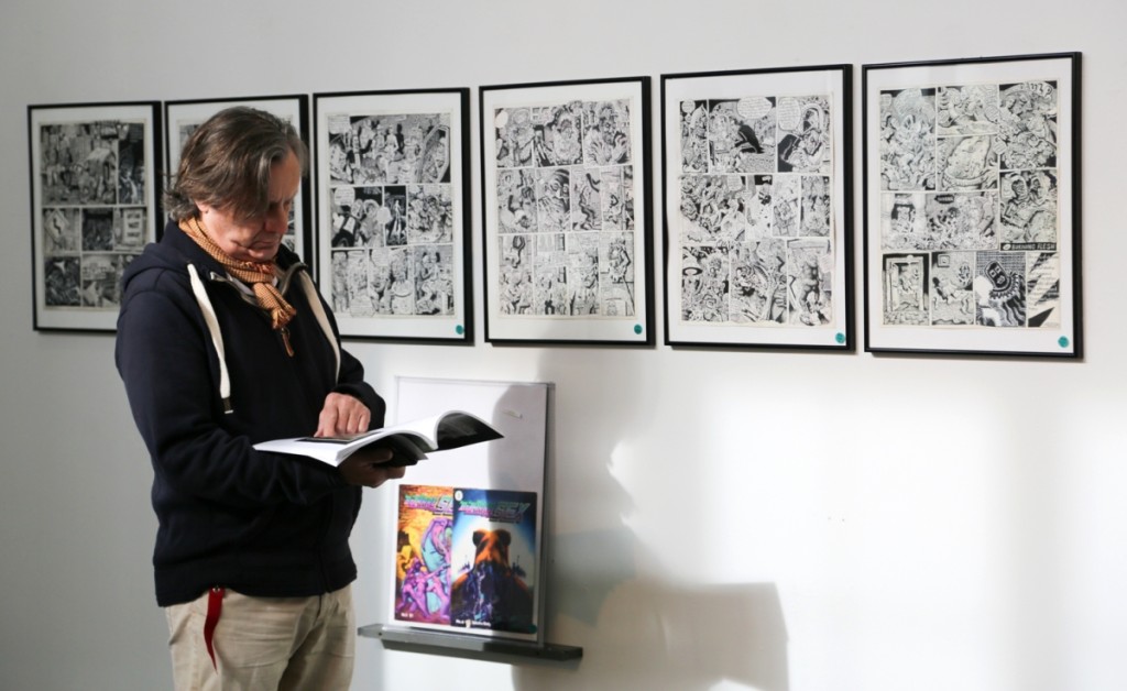 A previewer stands in front of the complete set of six original broadsheet artworks for Joe Coleman’s first published graphic story, Highay, which was published by Kitchen Sink Press in its underground comic Bizarre Sex 1977 #6. It sold just under the low estimate at $17,500.