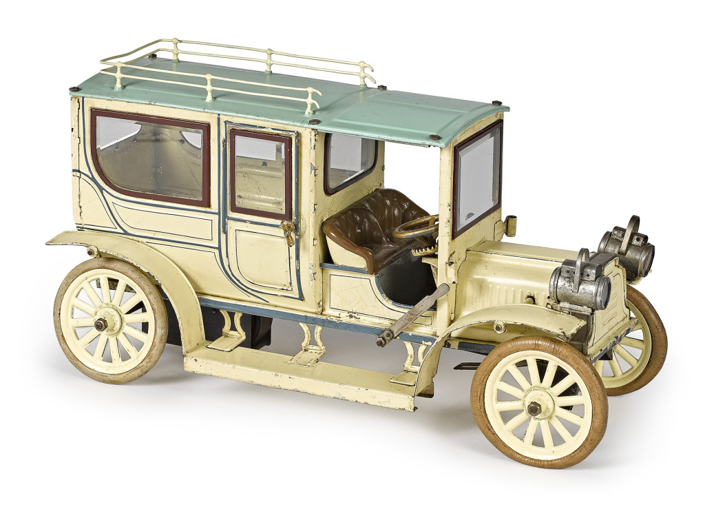 Selling for $14,640 was Lot 529, a large Carette tinplate clockwork limousine with a cream and teal blue surface, faux upholstered seat, beveled glass windows and roof rack. It measures 16 inches long and sold for $14,640, over the $12,000 high estimate.