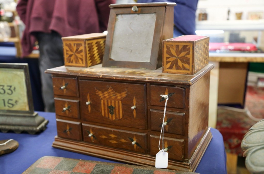 This nice little marquetry sewing box, complete with mirror and its original drawers, brought $604.