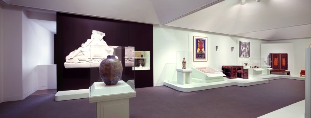 The contrast between Deco designs for the luxury trade as opposed to the mass market is illustrated by this juxtaposition at the exhibition entrance. In the foreground is an elegant 1932 Sevres “Mappemonde” vase, at the back a streamlined wall relief which once decorated the 1939 Rio movie theatre in St Louis. 															       —Lynton Gardiner photo