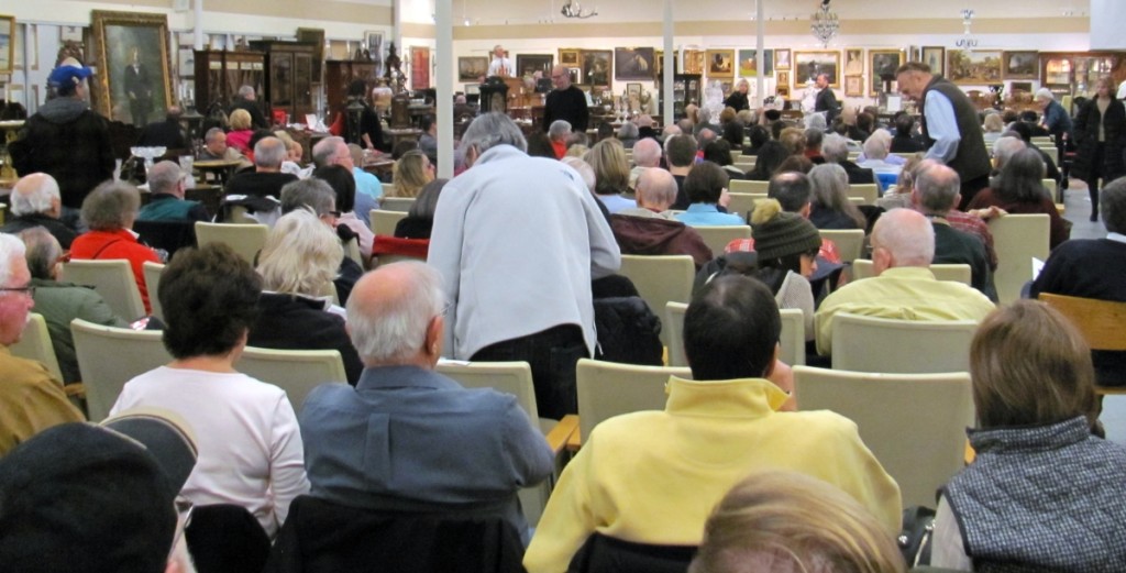 Standing at the front of the room and barely visible in this photo is Edwin “Ed” Nadeau Jr shown reading the conditions of sale just before the sale got underway. It was a capacity crowd, with many bidders opting to sit on furniture lots.