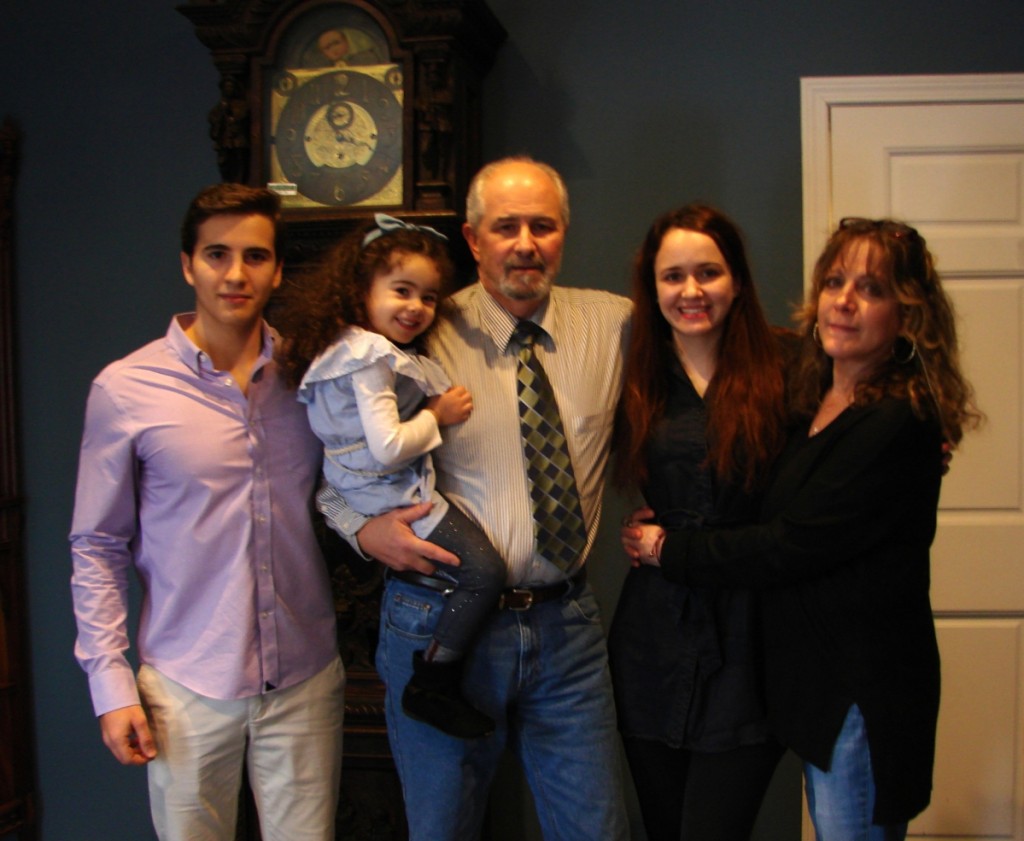 Three generations of the Fontaine family. John is in the center, holding his three-year-old granddaughter Maria, with his son John to his left. Maria’s mother, Mia, is on his right, along with her sister, Dina. At one point, Fontaine stopped the auction so that Maria could sing her favorite song to the audience.