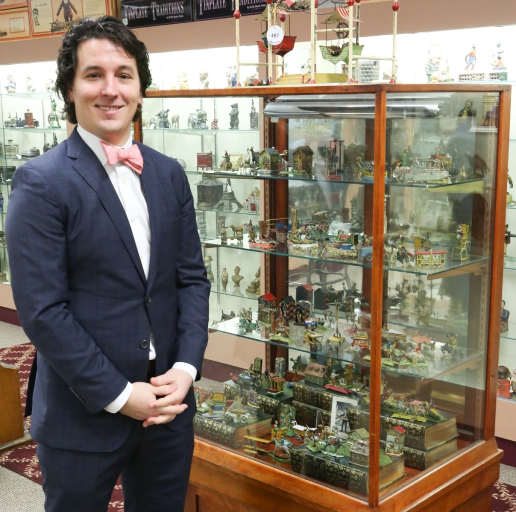 Michael Bertoia stands with his collection of penny toys. Bertoia began collecting them with his father, Bill Bertoia, when he was ten years old, and two decades later was willing to part with them in pursuit of other areas of collecting interest. He kept half of the remaining collection to pass down to his son, Aldo William Bertoia.