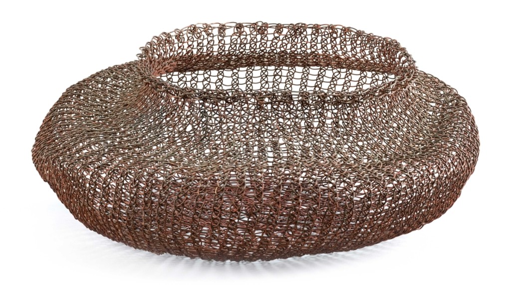 Artist Ruth Asawa (1926–2013), California and North Carolina, created this free-form basket in the late 1940s. Constructed of woven enameled copper wire, it measures 6 by 14½ inches. Opening with a strong $20,000 bid, active bidders from the phone and internet pursued it until sold at $72,000