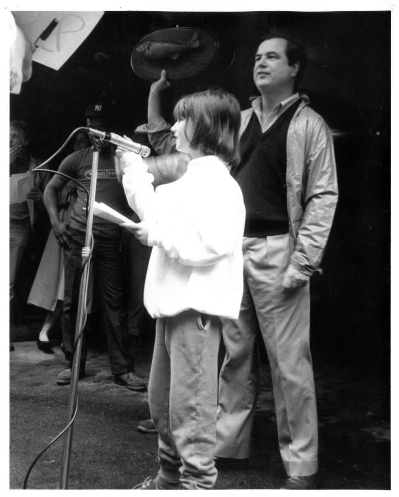 A young Laura Doyle tries her hand at auctioneering   with her father, William Doyle, behind.