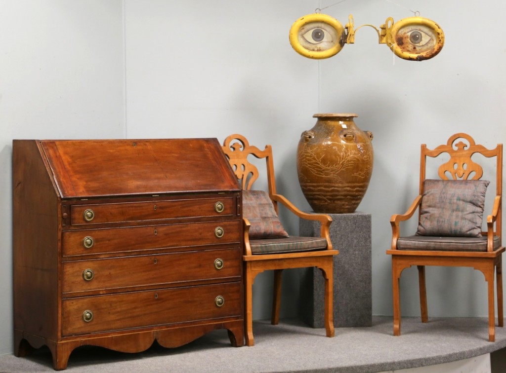 This vignette saw some ups and downs. The pair of chairs took $126, the Chinese handled jug brought $287, the Federal mahogany slant front desk went out at $150 and the optometrist trade sign sold for $805.