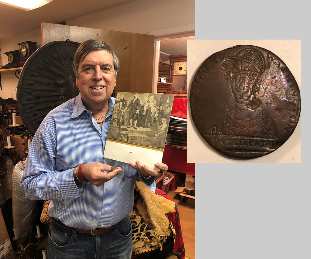 Auctioneer Tim Chapulis stands with the top lot from the sale, a George Washington inaugural button. See the inset photo for a detail. The button brought $30,000 to a private collector.  