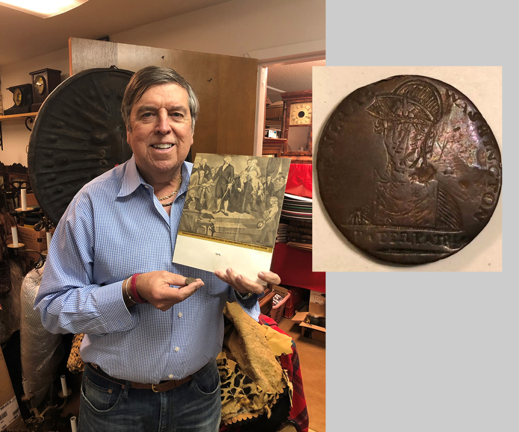 Auctioneer Tim Chapulis stands with the top lot from the sale, a George Washington inaugural button. See the inset photo for a detail. The button brought $30,000 to a private collector.
