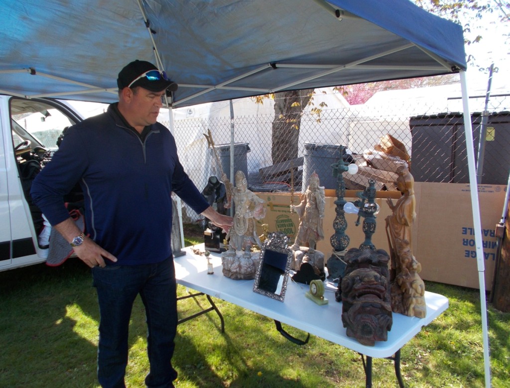 Andrew Ford of Sarasota Estate Auctions, Sarasota, Fla., explains some of his Asian antiquities to an off-camera shopper. 			         —May’s Antique Market