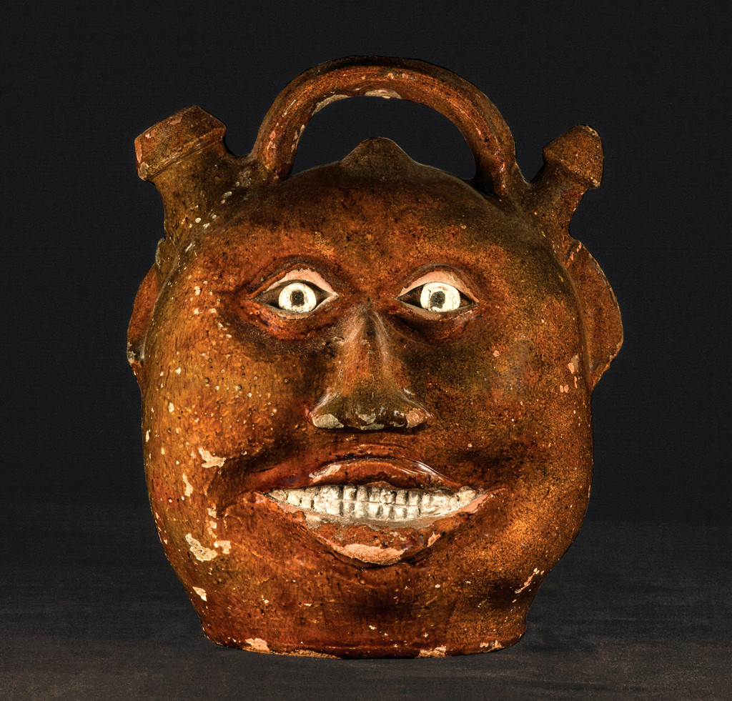 Harvest face jug attributed to Thomas Chandler (1810?–1854), Baltimore, Md., 1825–29. Earthenware with clear lead glaze and white painted details; height 10 inches. 