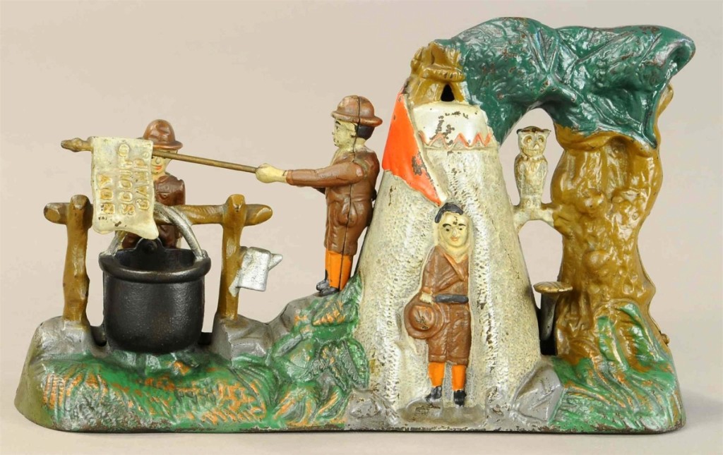 A mechanical bank Boy Scout Camp depicting three scouts holding a flag over campfire beside tepee, listed as all original in excellent to pristine condition, brought $7,200, over the high estimate of $6,000. This bank was made by J.&E. Stevens.