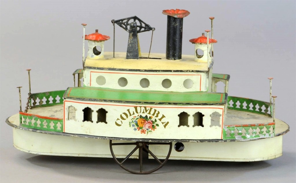 Brightly painted tin with stenciling and floral patterns reading Columbia adorns the sides of an Althof Bergmann Columbia Ferry Boat which is in pristine condition. This great surviving American toy, 13 inches long, sold for $40,800, well above the high estimate of $30,000.