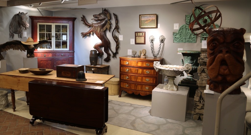 Brennan and Mouilleseaux Antiques had several standout pieces, including the painted corner cupboard, shown at the left here, and the oversized carved bulldog’s head, circa 1950, shown far right. Briarcliff Manor, N.Y.