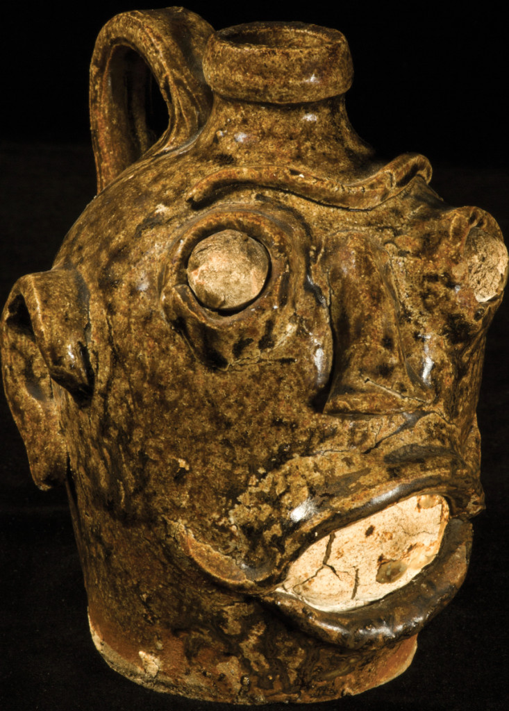 Face jug attributed to Dave (1800–circa 1870), Stoney Bluff, S.C., circa 1848–67. Dark ash glazed stoneware, kaolin eyes and teeth, height 6½ inches.