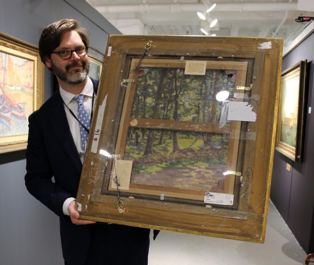 Zachary Hall showing the reverse of Raoul Dufy’s “La Cite, Vue de L’Hotel de Ville,” to show that Dufy frequently reused canvases; it was one of a few works in the booth that had works on the reverse. Trinity House Paintings, New York City, London and The Costwalds.