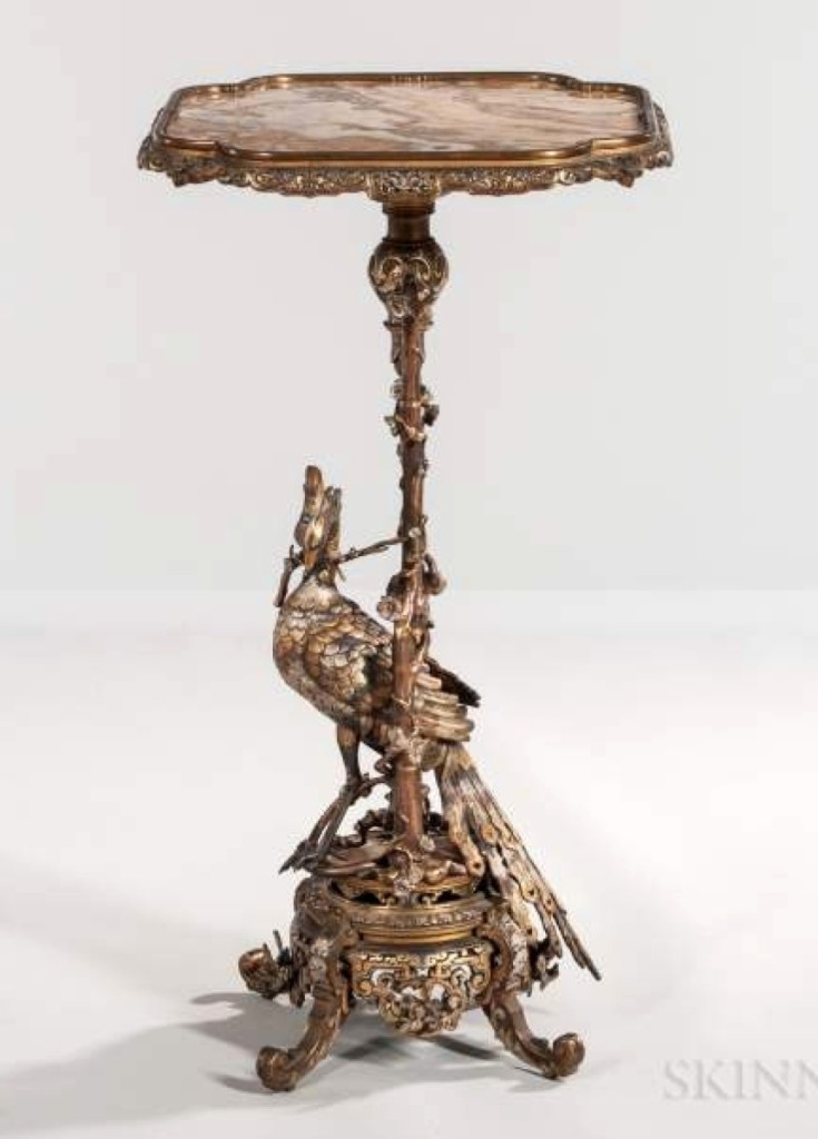 Selling for $23,370, more than 20 times its low estimate, was this Japonisme gilt and silvered bronze figural gueridon with an onyx top ($1/1,500).