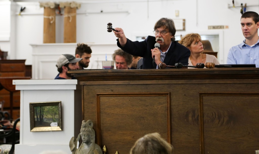 Russ Carlsen calls the sale from the podium with a lively gavel in his hand.