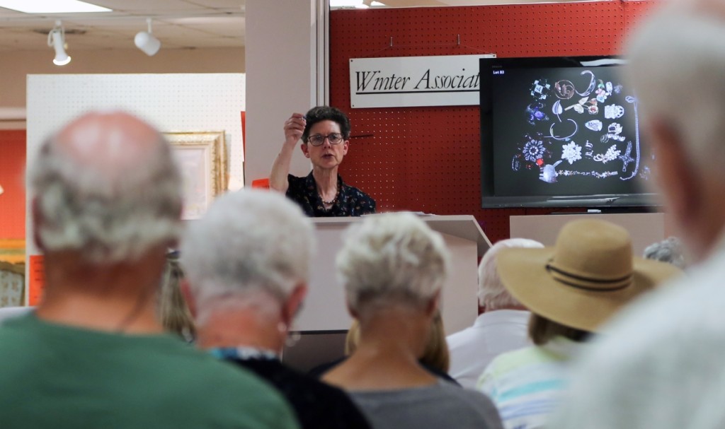 Linda Stamm calls the sale from the podium. Following the start of her firm four decades ago, Stamm recalled practicing auctioneering in her car to get the process right. Now a true veteran, Stamm is quick to command bidding here for her July 15 sale, where approximately 50 people sat in the gallery.