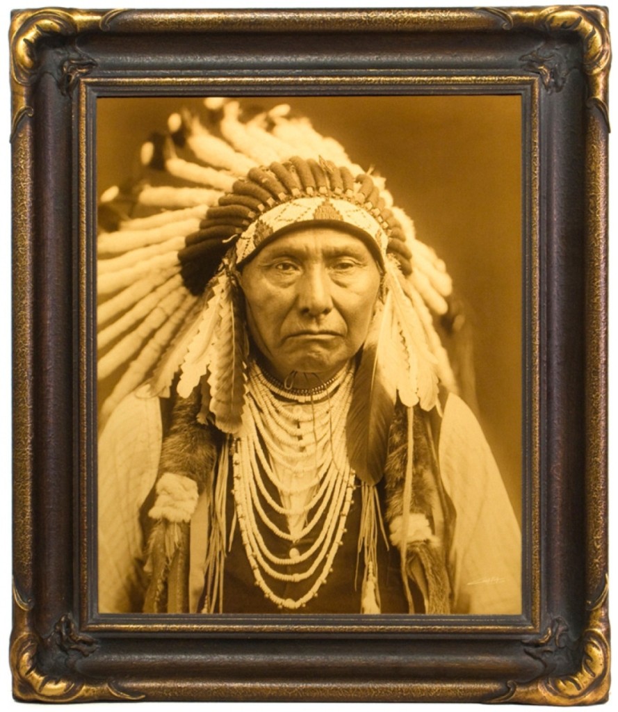 A gold tone of Edward Curtis’ portrait of Chief Joseph in ornate bat wing frame, printed by Paul Unks, Mountain Hawk Fine Art, Denver.