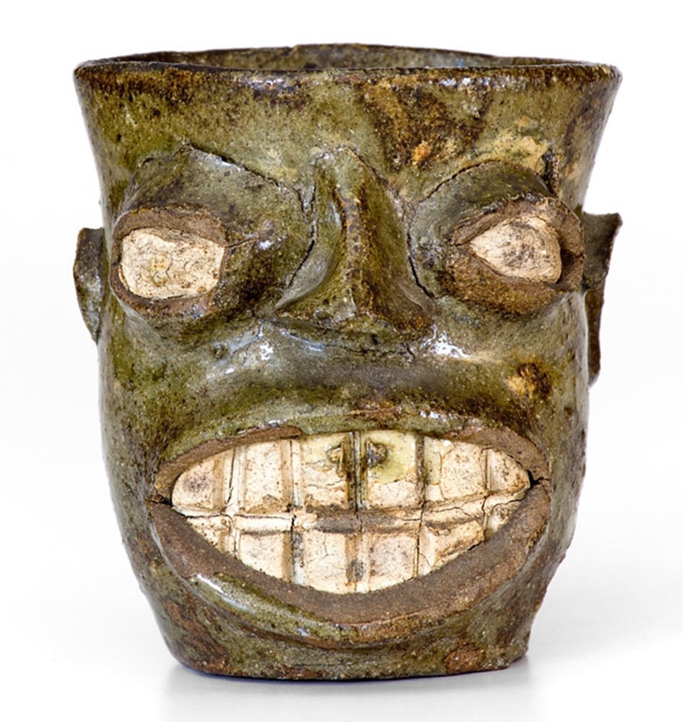 Rare and expressive Edgefield, S.C., alkaline-glazed face cup, circa 1855–70, fetched $70,800.