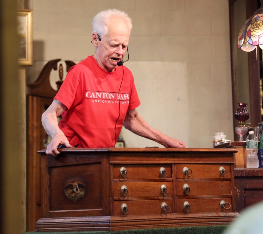 Wacht hopped off the podium to show off the original painting on the side of this spool cabinet. It had an inkwell on the lift top and the painting on the side featured an eagle. It sold for $320.