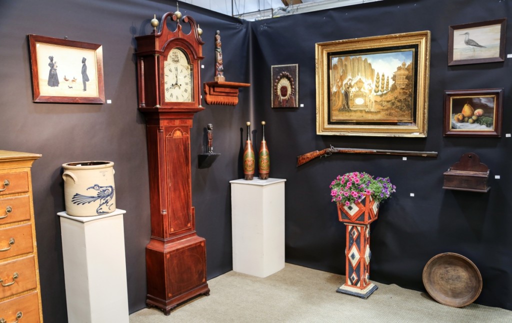 Jim Grievo, Stockton, N.J., said he had a great show. In addition to a number of smalls, he sold the two-handled crock with the bird decoration pictured here to a buyer. Also shown here is a Flemington, N.J., case clock; a pair of Shriners of New York City clubs in original condition; and a Nineteenth Century Fallwell needlework from Philadelphia above a Kentucky tiger maple rifle signed J.M Wood.