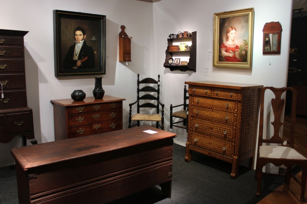 With Nathan Liverant and Son, Colchester, Conn., were, clockwise from upper right, a portrait of Caroline A. Pease holding flowers above a geometric inlaid tall chest attributed to Harrison Webber of Reading, Penn., a William and Mary linen fold-carved blanket chest from the Connecticut River Valley and a portrait of a sea captain attributed to Fredrick Mayhew.