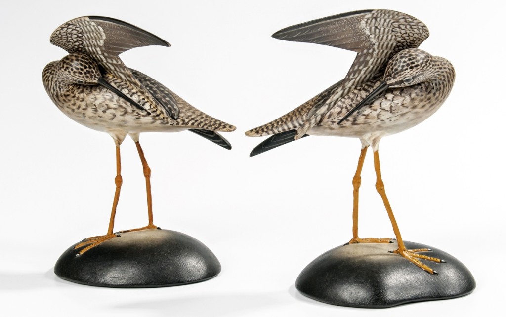 A nice pair of carved and painted preening yellowlegs, each with the rectangular Elmer Crowell mark on the base, realized $20,910. The sale included a number of decoys and decorative carvings.