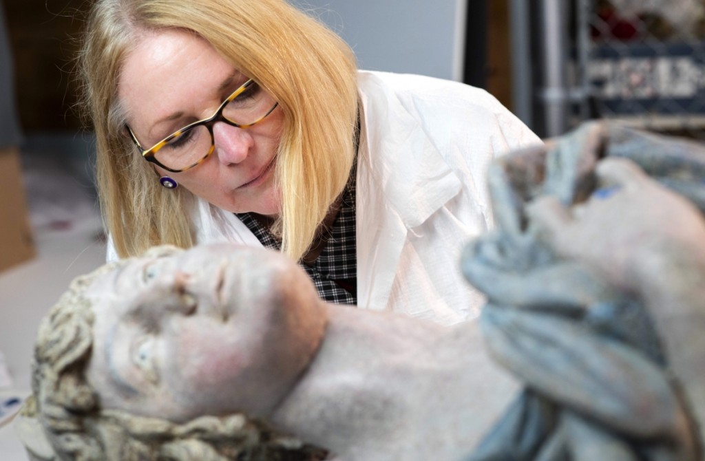 Figurehead with conservator Mimi Leveque. Photography by Bob Packert and Walter Silver. ©Peabody Essex Museum