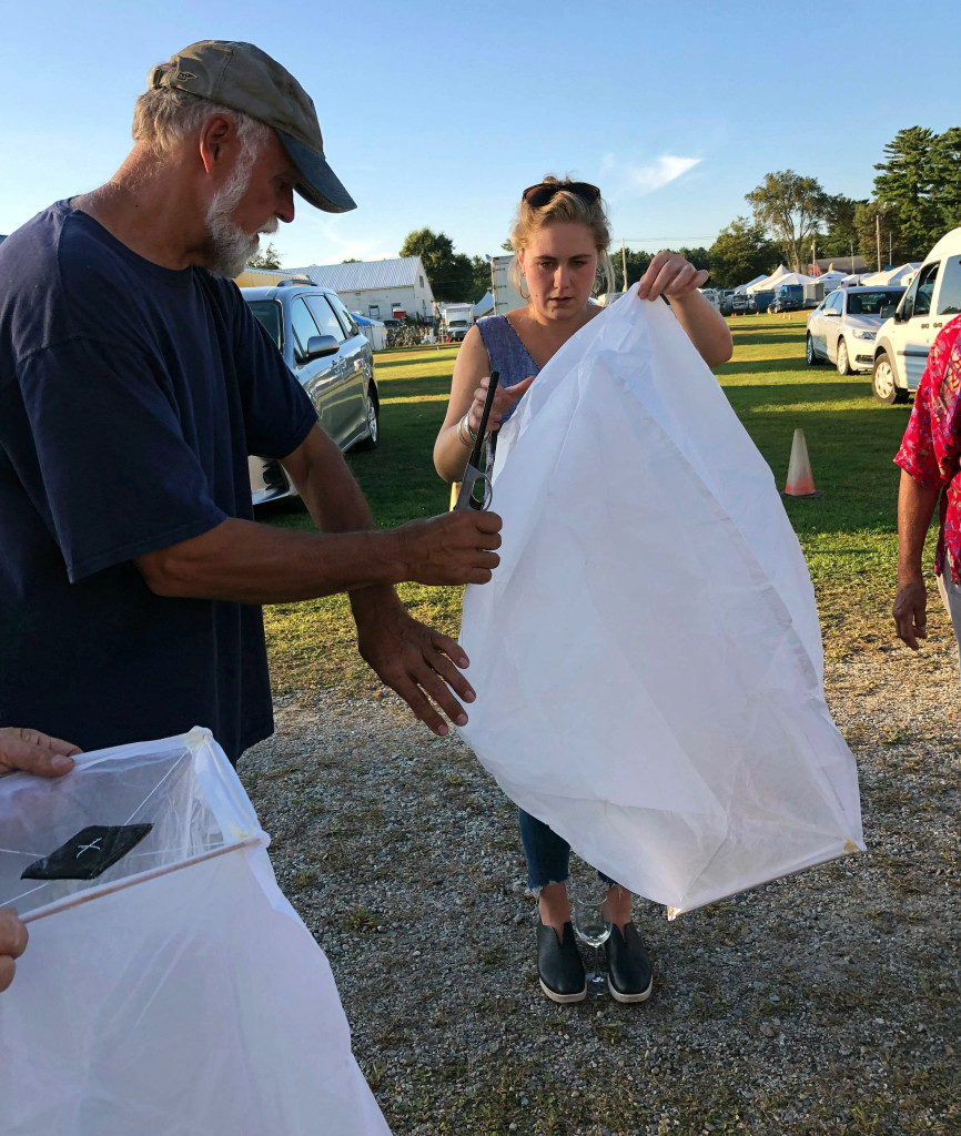 Portsmouth, N.H., dealer Bob Withington and Chloë Rohn of Montage Antiques in Millerton, N.Y., prepare sky lanterns for release.