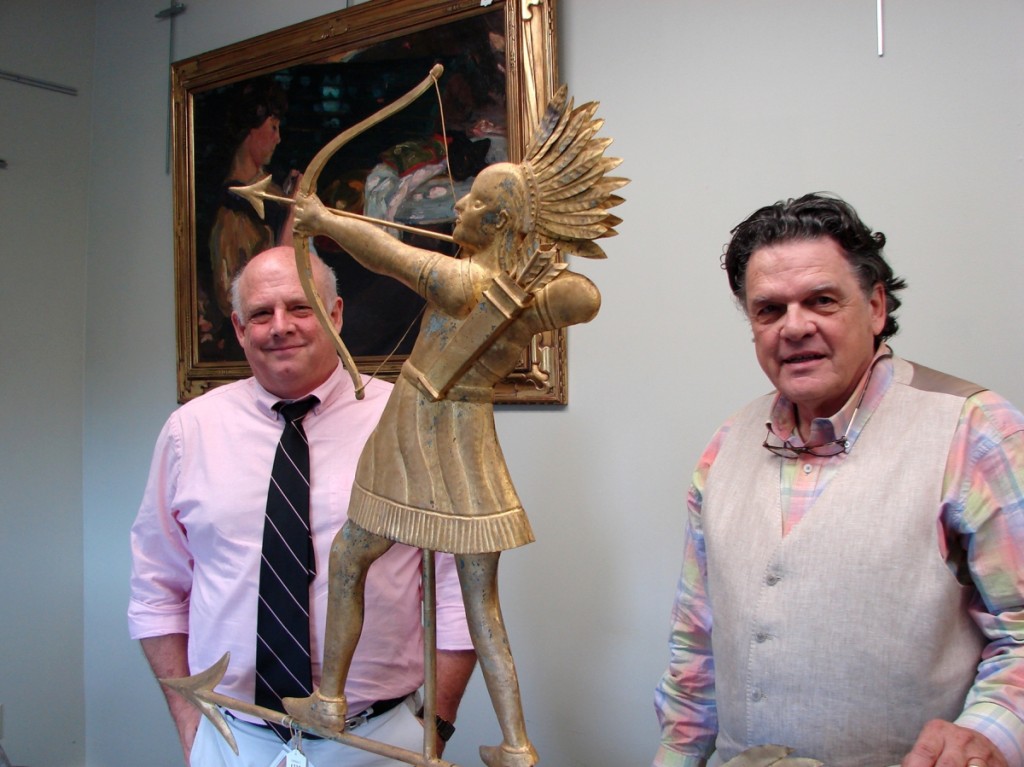 Kaja Veilleux, right, and John Bottero, vice president, with the Indian chief weathervane that sold for $33,930.